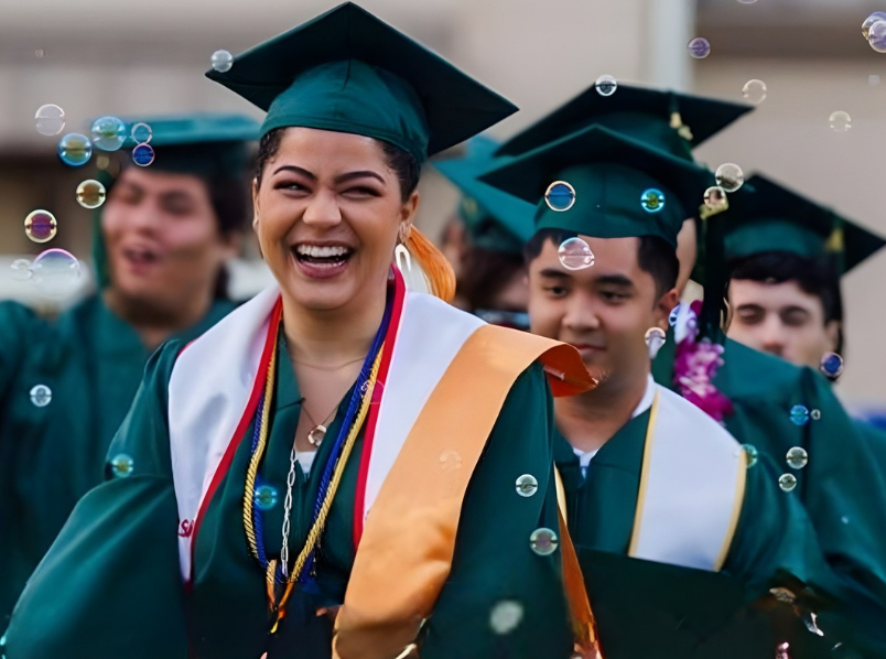 smiling grad walking